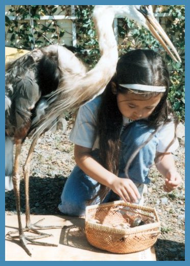 Girl with blue heron and blue heron's prey